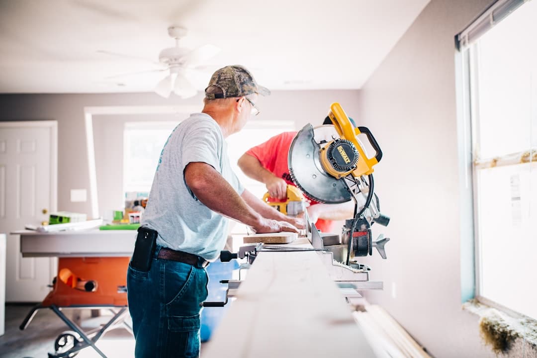 Carpenter cutting trim stock on a miter saw