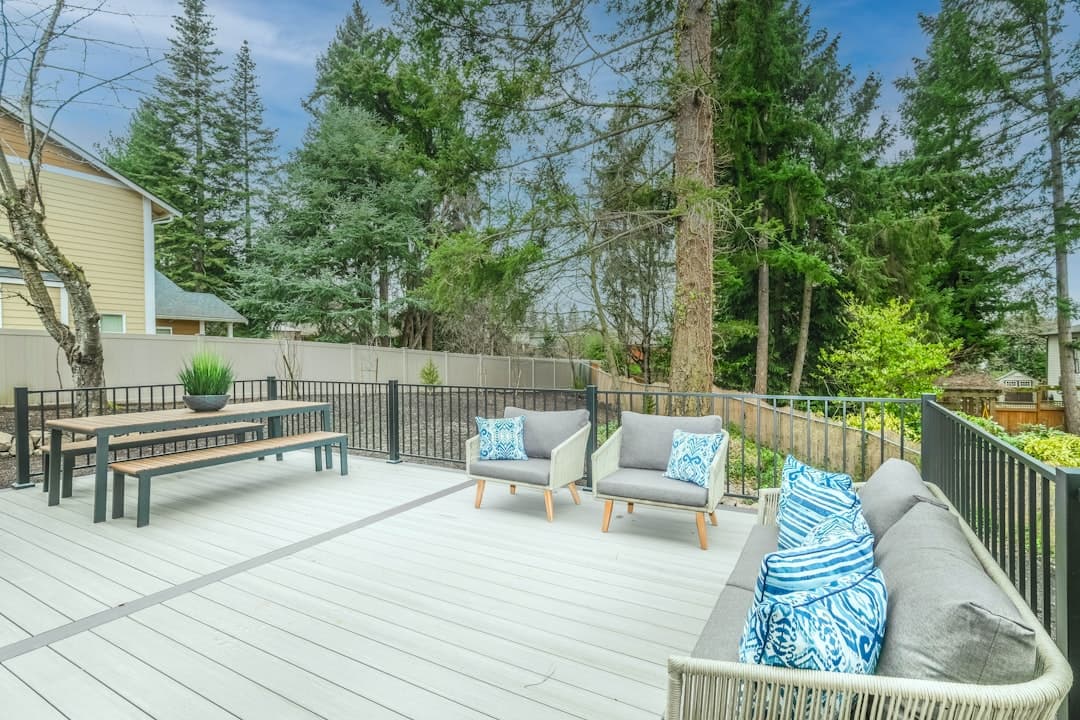 Wooden backyard deck with a bench and railing