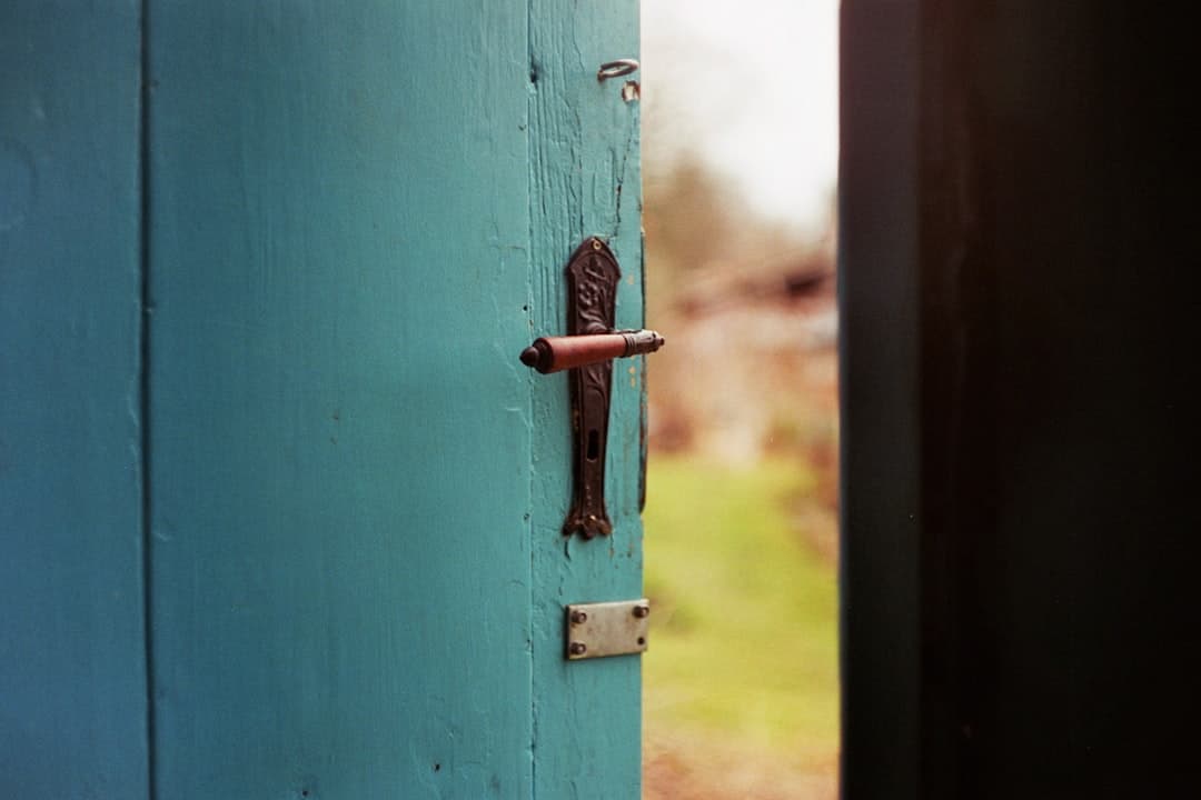 Painted wooden front door with weathered hardware